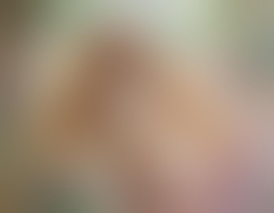 A captivating and ethereal scene of a graceful nude female figure adorned with flowing long blonde hair, surrounded by soft pastel colors. Emphasize the feminine radiance with natural light illuminating the curves and contours of the body. Incorporate delicate floral elements intertwined with the hair to symbolize beauty and artistry. Create an enchanting and dreamlike atmosphere that celebrates the allure of artistic nudity. soft painting style. vibrant colors.